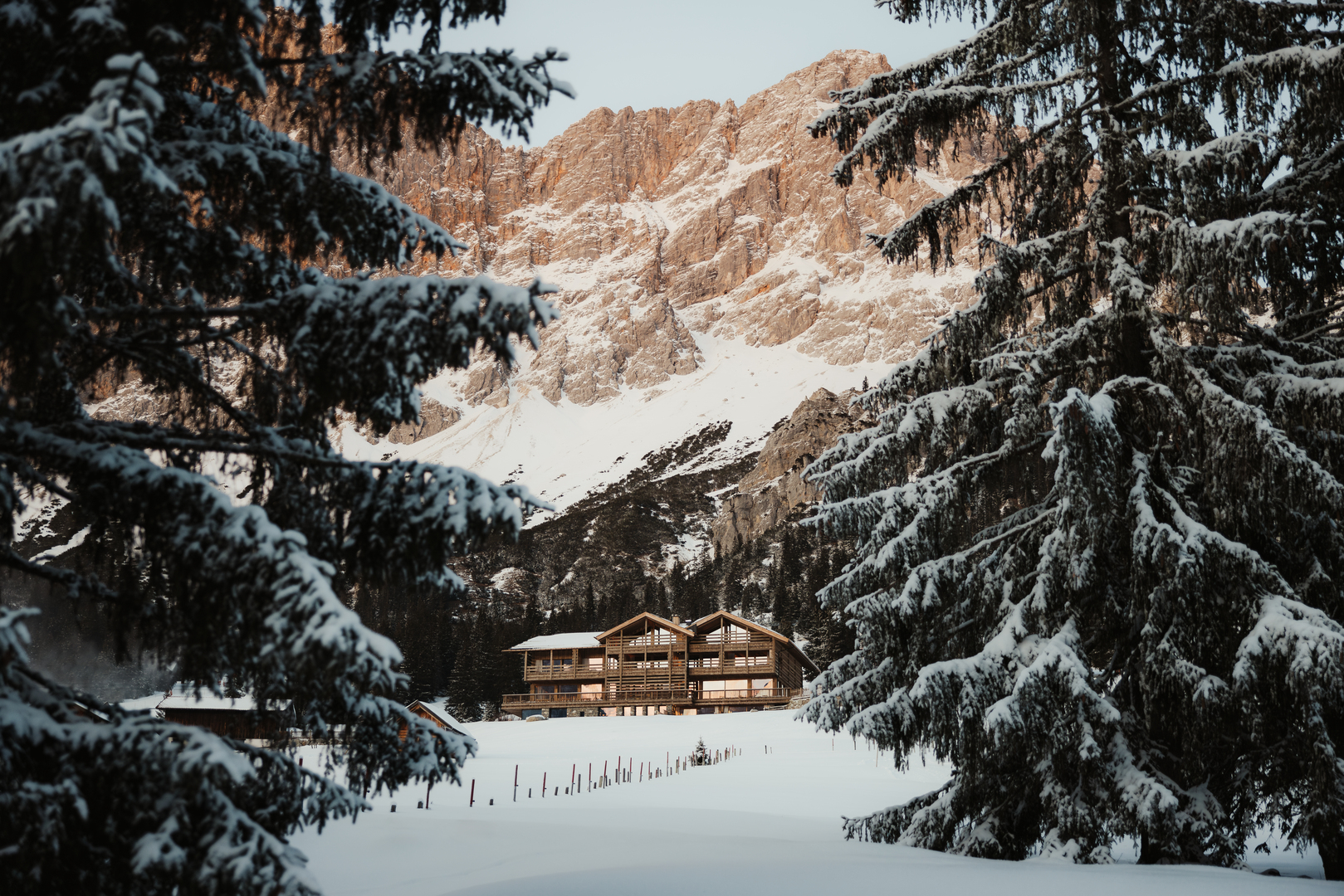 Snow-covered lodge in Ehrwald, Austria, nestled in a snowy mountain landscape.