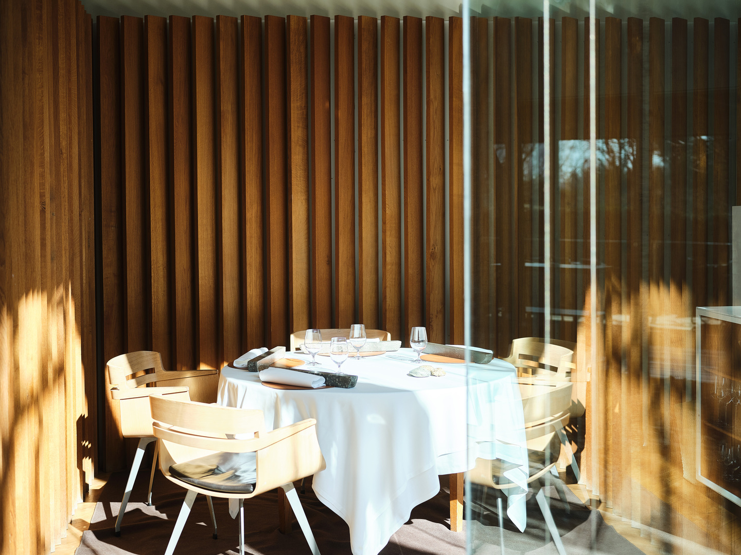 Table set for a meal in a restaurant with wooden walls.