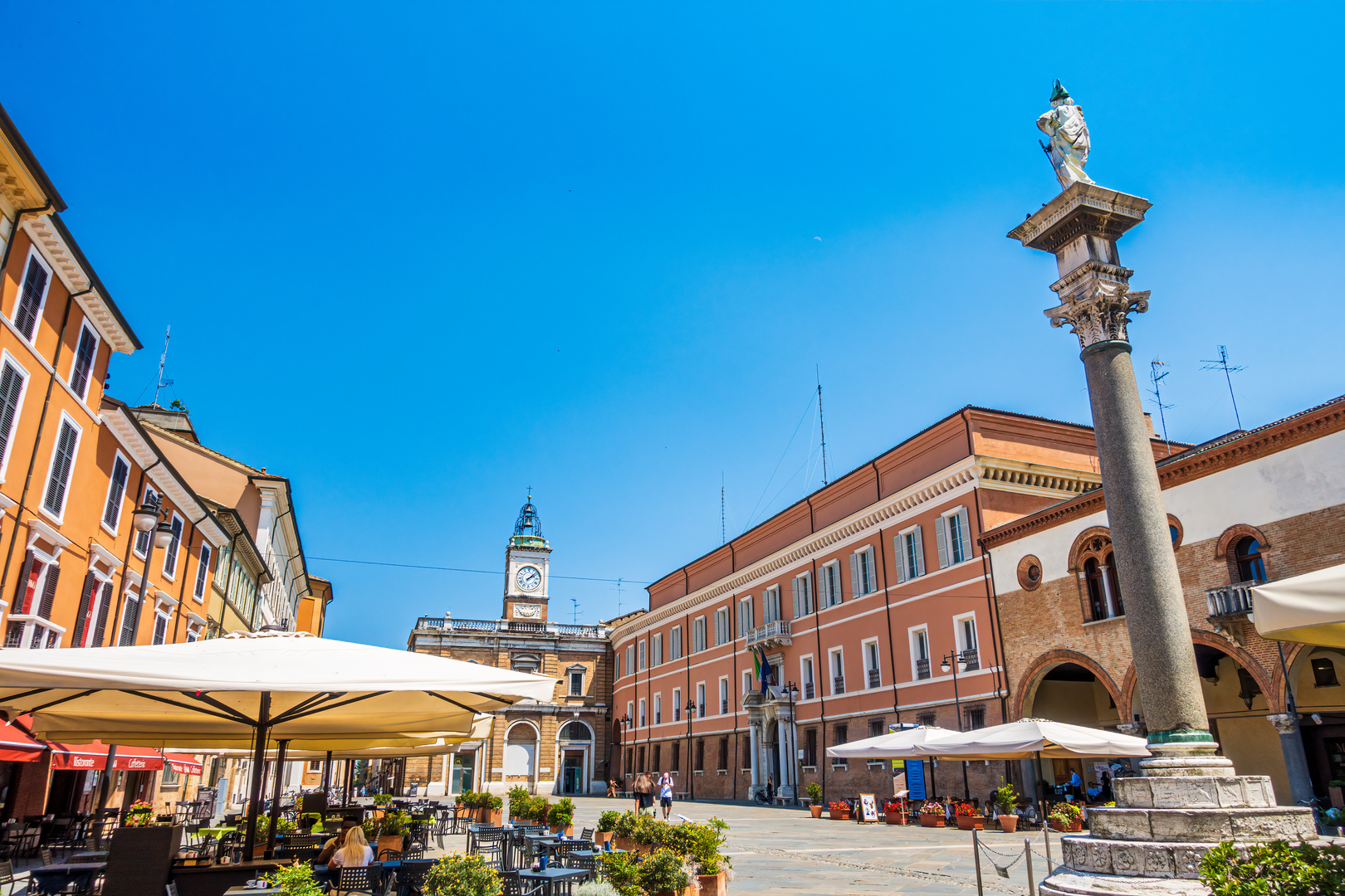 Piazza del Popolo in Ravenna, Italy, featuring a column, clock tower, and outdoor cafes.