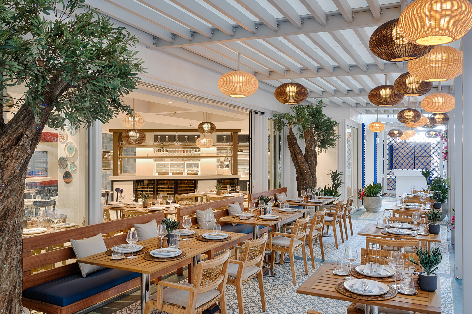 Alfresco dining area with wooden furniture under a pergola.