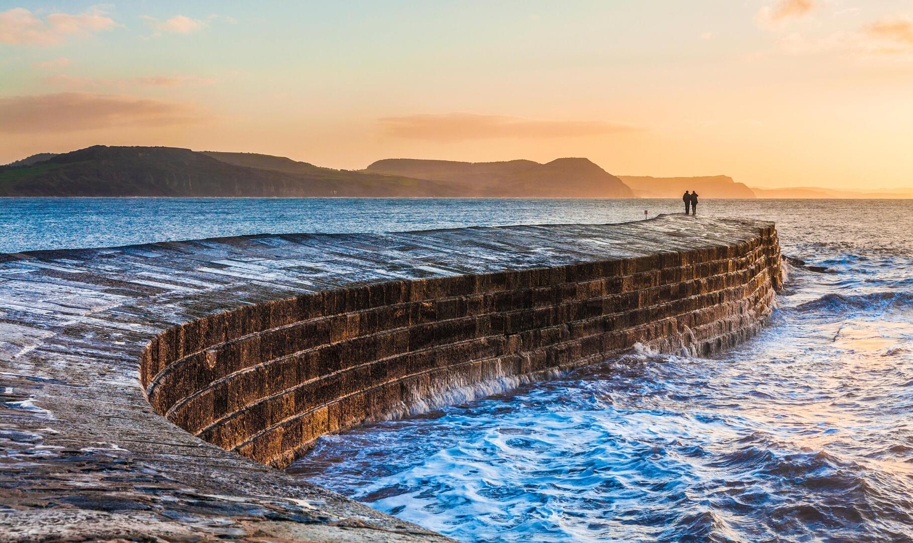 Sunrise over the Cobb at Lyme Regis in Dorset.