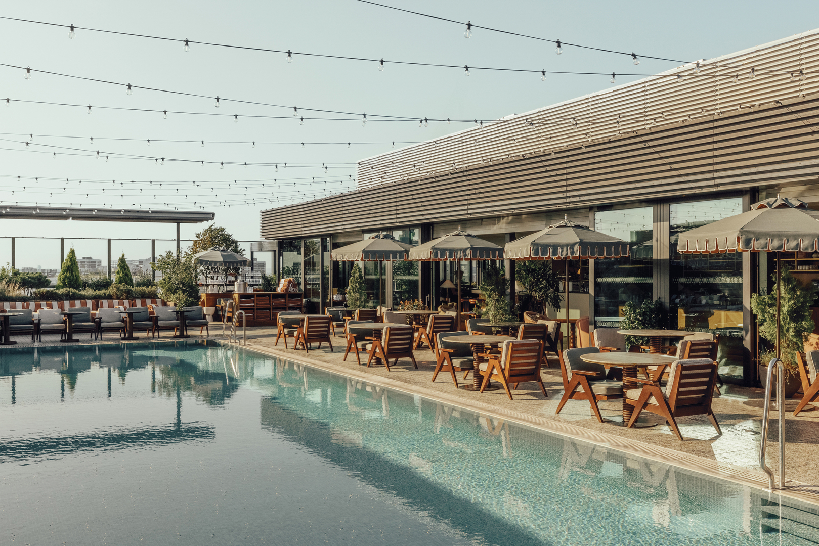 Soho House White City rooftop pool and patio seating.