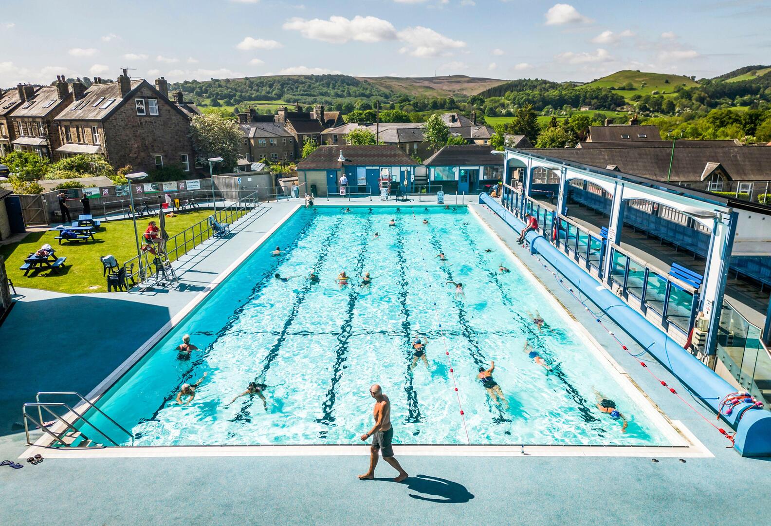 People swimming at an outdoor pool.
