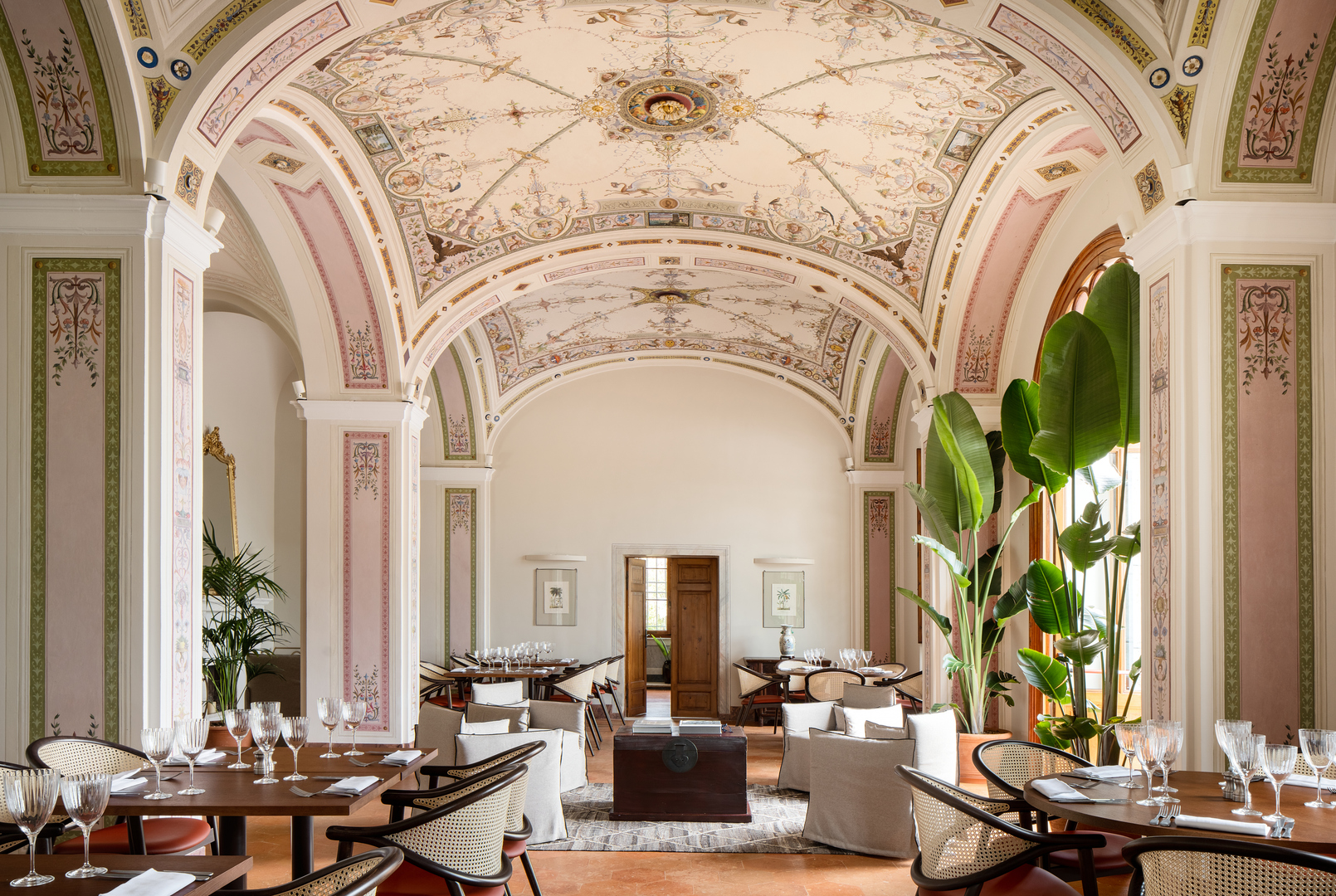 Dining room interior showcasing arched ceilings adorned with painted frescoes.