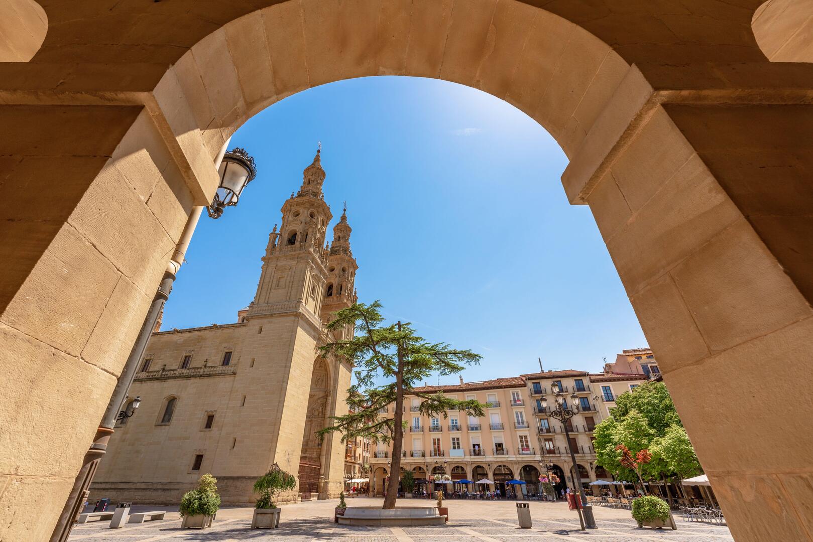 View of the Santa Maria de la Redonda Cathedral in Logrono, Spain, seen through an archway.