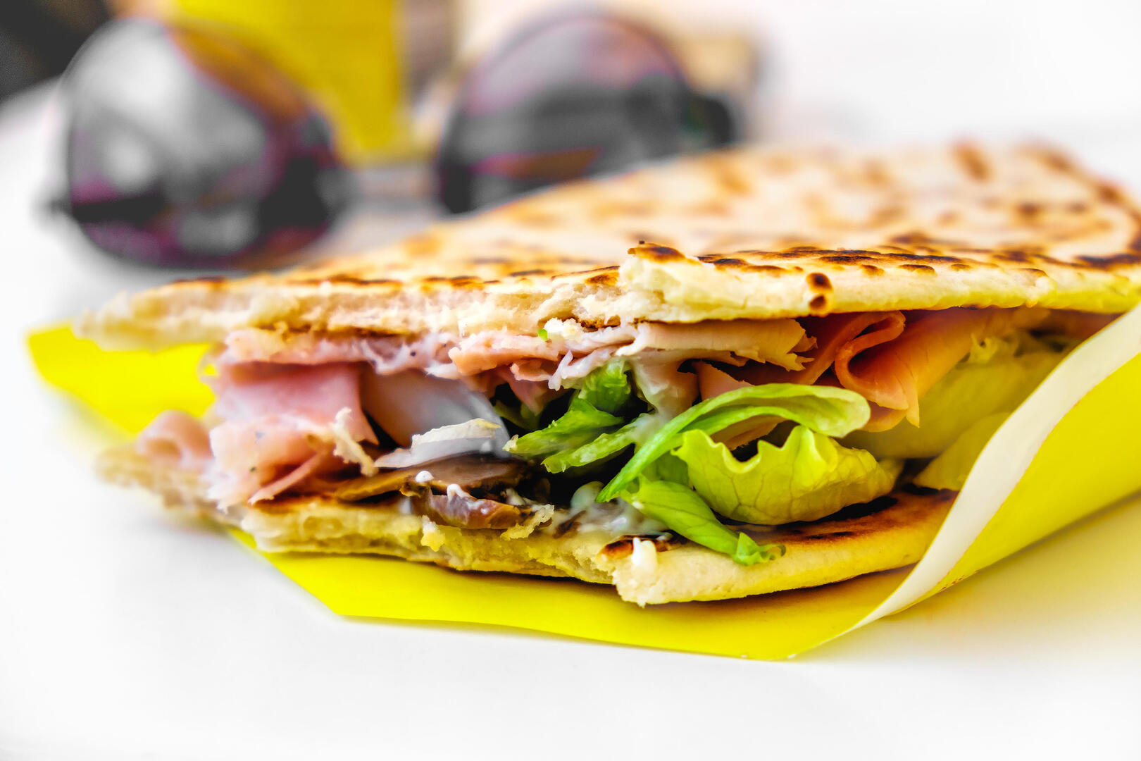 Piadina Romagnola with ham, mushrooms, and lettuce.