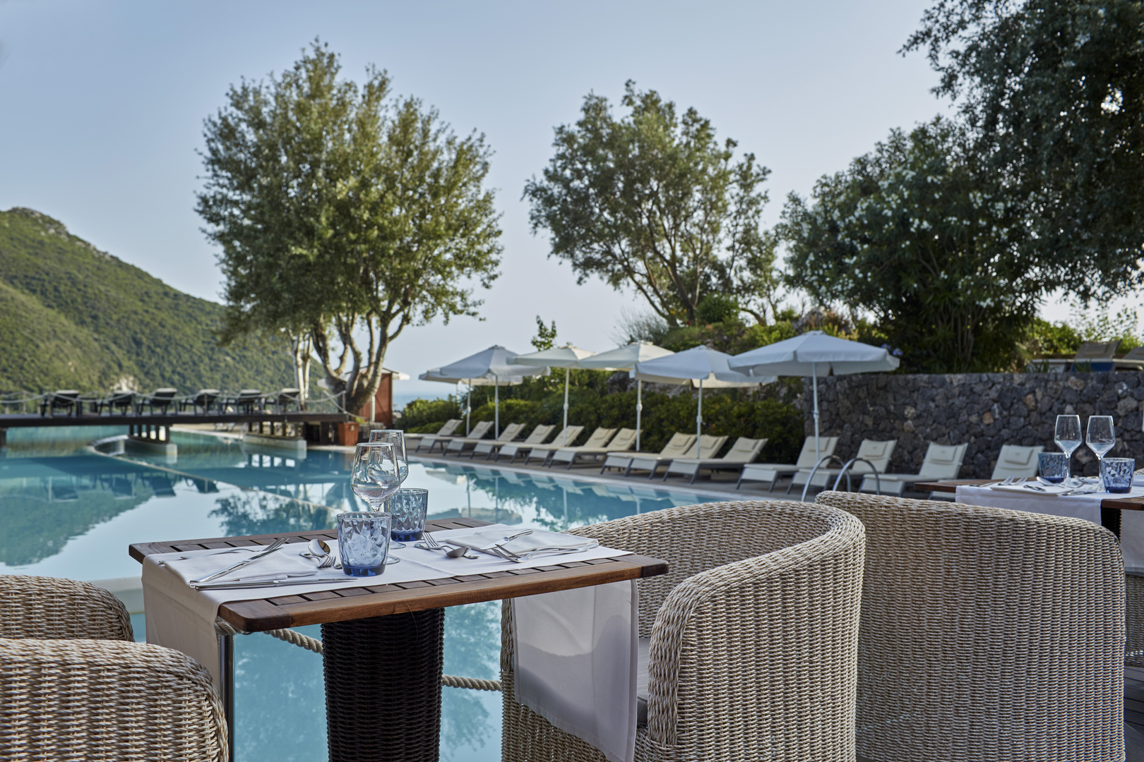 A table set for dinner beside a swimming pool at Atlantica Grand Mediterraneo Resort